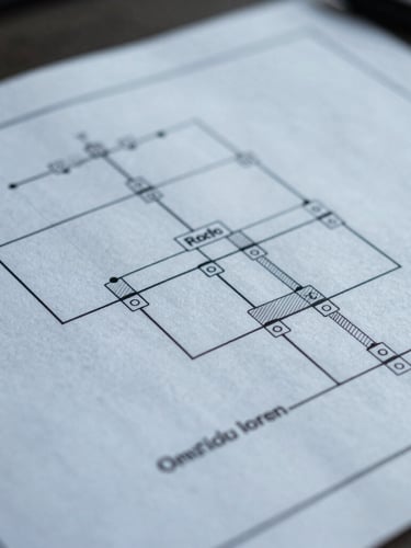 A crisp macro photograph of a structured system architecture diagram printed on technical blueprint paper, cool daylight, sharp lines, no text