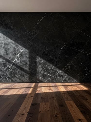 One-point perspective of a minimalist luxury interior, dramatic natural light casting long shadows across a massive veined black marble wall and dark oak floor, architectural restraint.