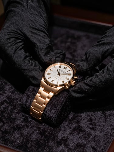 Close-up of gloved hands carefully holding an exquisite luxury watch over a dark velvet surface, low-key dramatic lighting, gold highlights, 35mm editorial photography