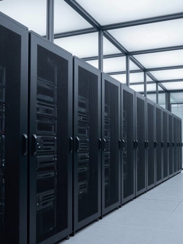 Wide architectural line of a clean, structured server room, cool overcast daylight filtering through glass panels, server racks aligned in deep perspective, no people.