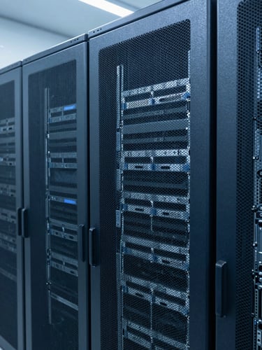 Sharp architectural photography of clean server racks in a modern data center, cool blue and slate gray tones, clean technical lighting, macro depth of field, 35mm