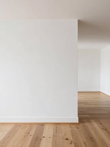 Architectural interior photography, bright natural daylight, clean white plaster textures, minimalist composition, sharp details, 35mm, wide-angle view of a modern living room where oak wood flooring meets a microcement wall transition.