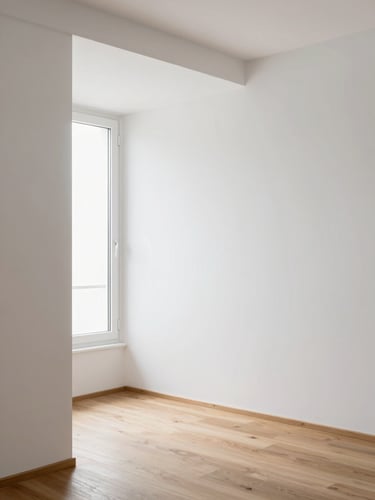 Architectural interior photography of a minimalist Spanish apartment, clean white plaster walls meeting natural oak wood flooring, soft daylight from a high window, sharp details, 35mm.