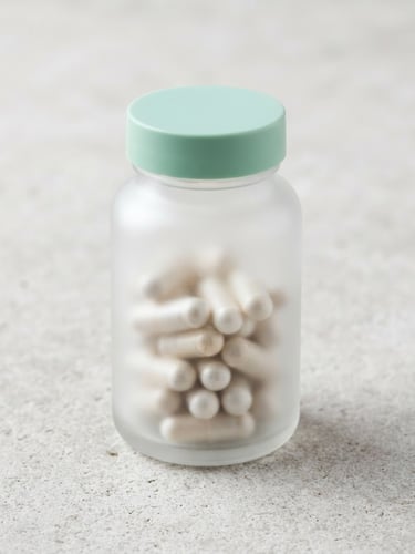 A clean frosted glass supplement bottle resting on a light gray stone backdrop, bright high-key studio lighting, soft clinical shadows, sharp macro focus, 50mm