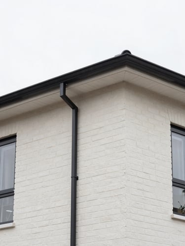 Close-up of clean, modern rooflines and precise brickwork on a newly completed Manchester home extension, sharp focus, 35mm