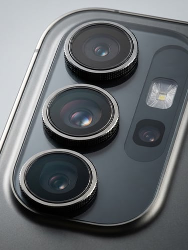Close-up macro shot of a sleek, modern smartphone's camera array, crisp studio lighting, clean light gray background, sharp details, high-contrast, 85mm lens