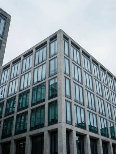 Low-angle architectural shot of a minimalist concrete and glass corporate headquarters in London, overcast cool daylight, sharp lines, 35mm photography