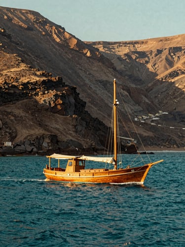 A boutique wooden sailing vessel glides through deep teal waters of the Aegean Sea, sun-baked volcanic cliffs in the background, warm light.