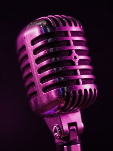 Abstract close-up of a glowing vintage microphone under dramatic magenta stage lighting, high-contrast shadows, 35mm film style