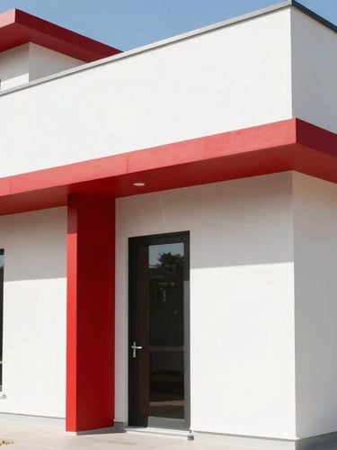 A clean modern home exterior with sharp shadows under bright natural daylight, architectural lines, high-contrast crimson accents
