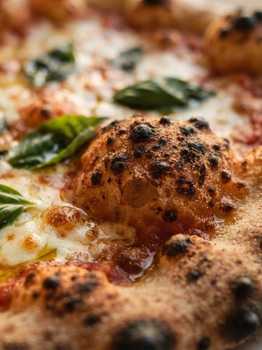 Close-up of a rustic sourdough pizza crust with bubbling charred spots, fresh basil leaves, and warm golden olive oil, soft natural light, 35mm