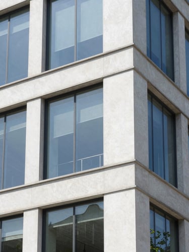 Crisp architectural detail of a newly renovated building facade meeting a clean glass office window, bright natural daylight, sharp focus, 35mm lens