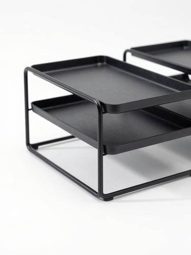 Crisp studio photography of a single matte-black steel desk organizer shot in isolation on a clean white background, bright high-key lighting, soft natural shadows, sharp focus, 50mm lens.
