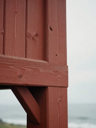 Close-up detail of weathered, hand-hewn redwood timbers with historic mortise-and-tenon joinery, soft natural side lighting, tactile wood grain, warm archival tone.