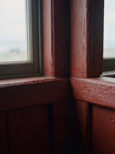 Medium close-up of weathered 19th-century redwood timber joinery, hand-carved mortise and tenon joints, soft natural window light casting gentle shadows, tactile wood grain, 35mm film photography.