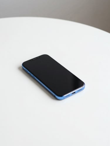 A clean minimalist photo of a smartphone lying flat on a stark white table, bright neutral daylight, crisp blue accents, sharp focus, 35mm
