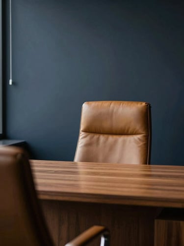 Elegant minimalist executive office interior, deep shadows, soft window light, warm leather and oak textures, shallow depth of field, 35mm