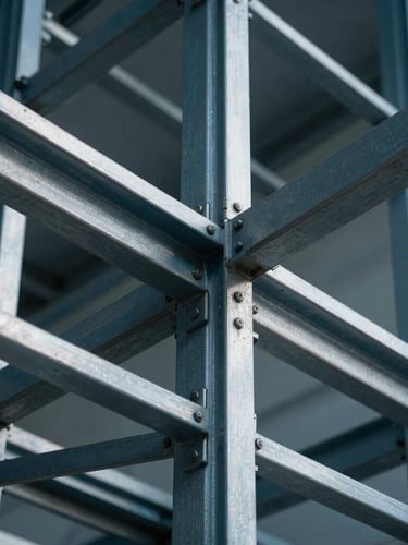 Extreme close-up of a structural steel grid layout, cool-toned blue and silver high-contrast studio lighting, sharp architectural lines.