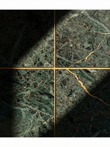 Close-up of premium dark green marble texture with gold veins, geometric brass divider line, high-contrast studio lighting, architectural detail