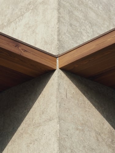 Extreme close-up architectural detail of raw concrete intersecting with premium dark oak wood, casting deep shadows under natural overcast daylight, medium format film look