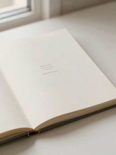 Overhead flatlay of an open minimalist book on a warm off-white paper surface, soft natural window light, clean typography visible on the page