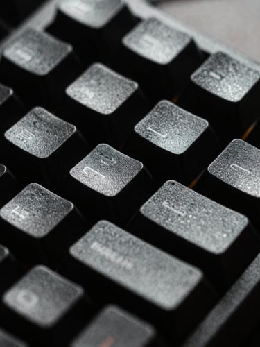 Extreme close-up macro shot of a rugged mechanical keyboard, harsh single-source cold light highlighting textured keycaps, deep black shadows, 35mm film grain.