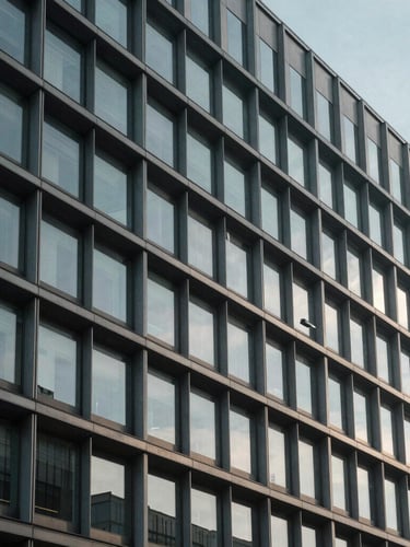 Wide panoramic architectural crop of a modern steel and concrete corporate headquarters facade, cool daylight casting soft shadows, minimal geometric structure.
