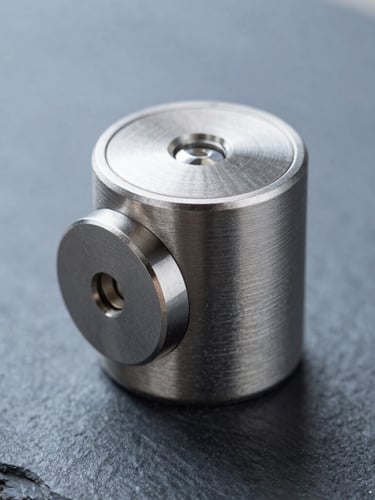 Macro shot of a premium brushed steel electronic lock cylinder, crisp cool natural light, sharp focus, technical minimalism, slate and blue tones