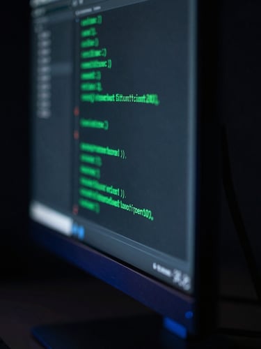 Macro shot of clean code on a vertical monitor, glowing emerald accents, dramatic studio lighting, deep shadows
