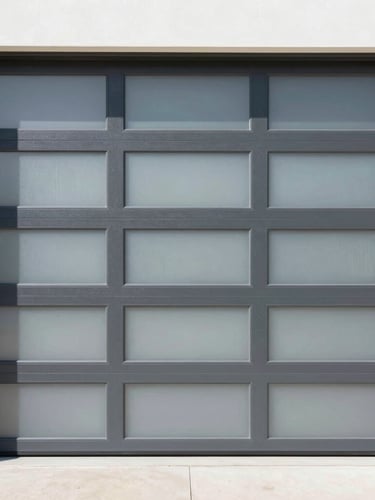 Straight-on architectural shot of a modern charcoal aluminum garage door with frosted glass panels, bright Florida daylight, clean shadows, 35mm lens