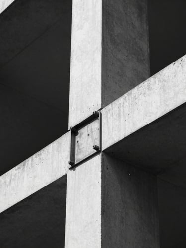 Extreme close-up of a steel joint connection in a modern building, stark natural light, high-contrast monochrome tones, sharp focus, technical architectural detail