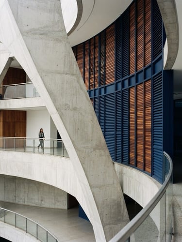 Architectural detail of a modern Brazilian municipal palace, clean concrete curves, soft daylight, navy shadows, editorial style