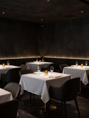 Dark dramatic interior of a twenty-four seat minimalist restaurant, low-key side lighting, sharp architectural lines, empty tables with crisp white linens and gold accents, 50mm lens