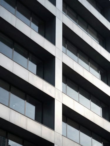 Sleek architectural photography of a modern high-end corporate headquarters facade, sharp geometric shadows, cool silver and deep obsidian tones, 35mm
