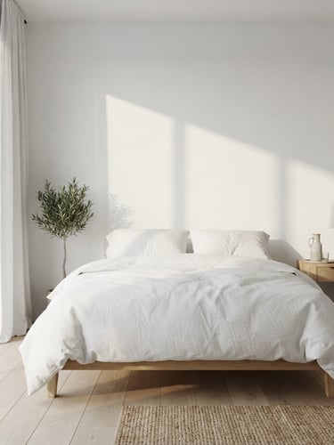 Bright architectural photo of a minimalist guest room interior, soft morning sun casting long shadows on white walls, crisp white bed linens, natural wood side table