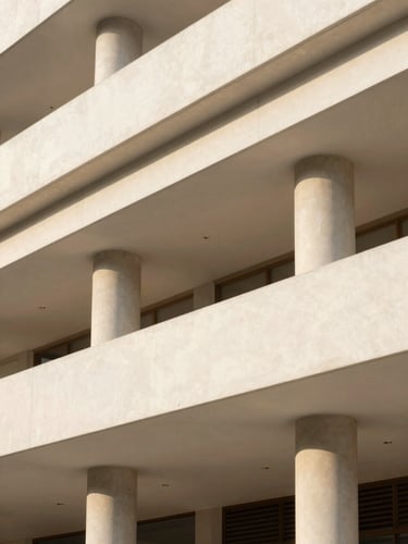 Bright architectural photography of a modern building facade in São Paulo, soft natural daylight, warm neutral tones, clean lines, 35mm