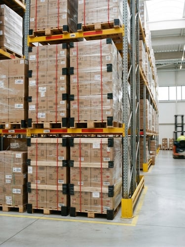 Clean industrial photography of stacked pallets in a clean, modern warehouse, bright daylight, high-contrast red accents, sharp focus, 35mm