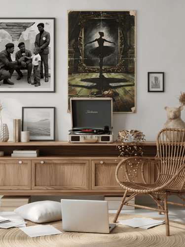 Artist workspace with laptop, vintage record player, and framed retro posters.