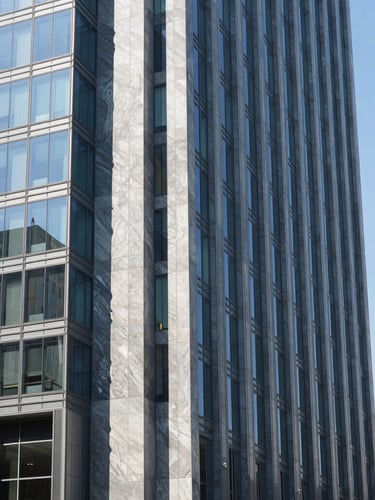 Modern corporate office building in Mexico City, clean architectural lines, bright natural daylight, cool blue glass reflections, sharp focus
