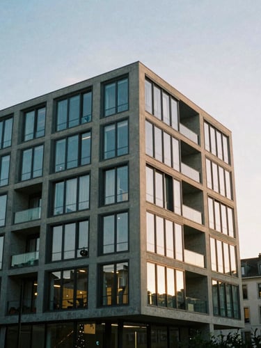 Modern concrete and glass apartment building in Geneva, sharp architectural angles, soft evening light, editorial style, 35mm
