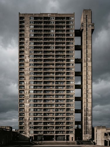 Stark architectural elevation of a brutalist concrete tower against a high-contrast gray sky, sharp shadows, 35mm film texture.