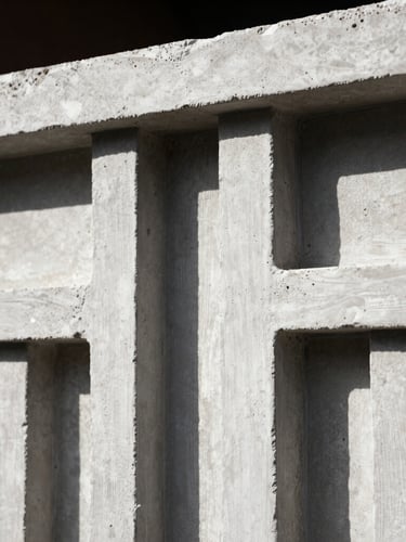 Extreme macro close-up of a raw plaster architectural model, deep shadows, harsh natural light, 35mm film texture