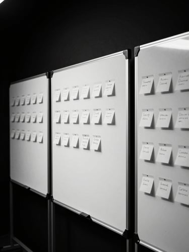 Behind-the-scenes workshop session with whiteboards and sticky notes, sharp high-contrast studio flash, deep shadows, monochrome, 35mm