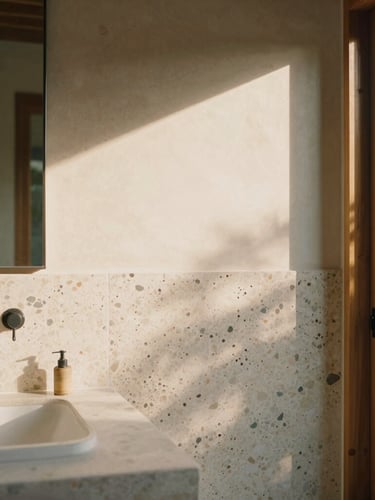 Tight tactile study of raw terrazzo and local stone in a sun-drenched Bali villa bathroom, soft golden-hour shadows.