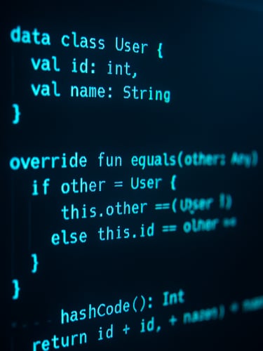 Close-up of a code editor with syntax highlighting in cool neon cyan and frosty blue, showing optimized Kotlin structures, moody ambient studio lighting