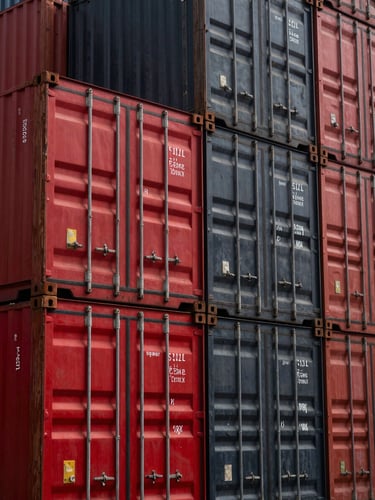 Close-up of secured red and black steel shipping containers stacked in a modern organized warehouse, dramatic industrial lighting, sharp textures.