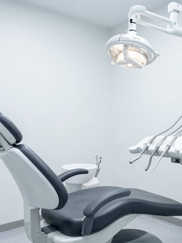 Wide architectural shot of a minimalist, clinical dental operatory, cool diffused lighting, matte-finish instruments visible, sterile slate gray tones.