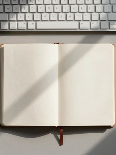 Top-down flat lay of a minimalist workspace, an open analog notebook, a brass pen, a clean mechanical keyboard, soft morning light casting long shadows, neutral tones.