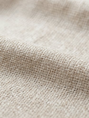 Macro detail of natural linen textile weave under soft, diffused northern daylight, showing precise structural thread alignment.