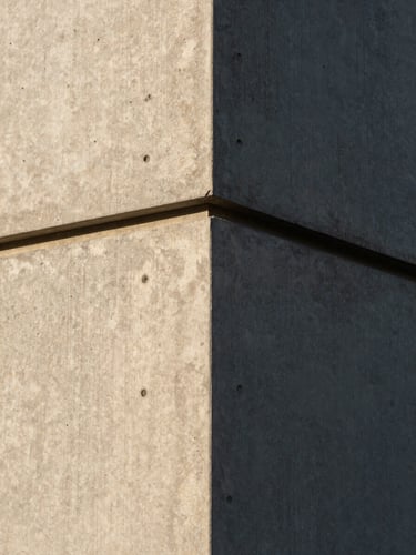 Extreme close-up of a crisp architectural concrete joint, sharp late afternoon shadows, rich material texture